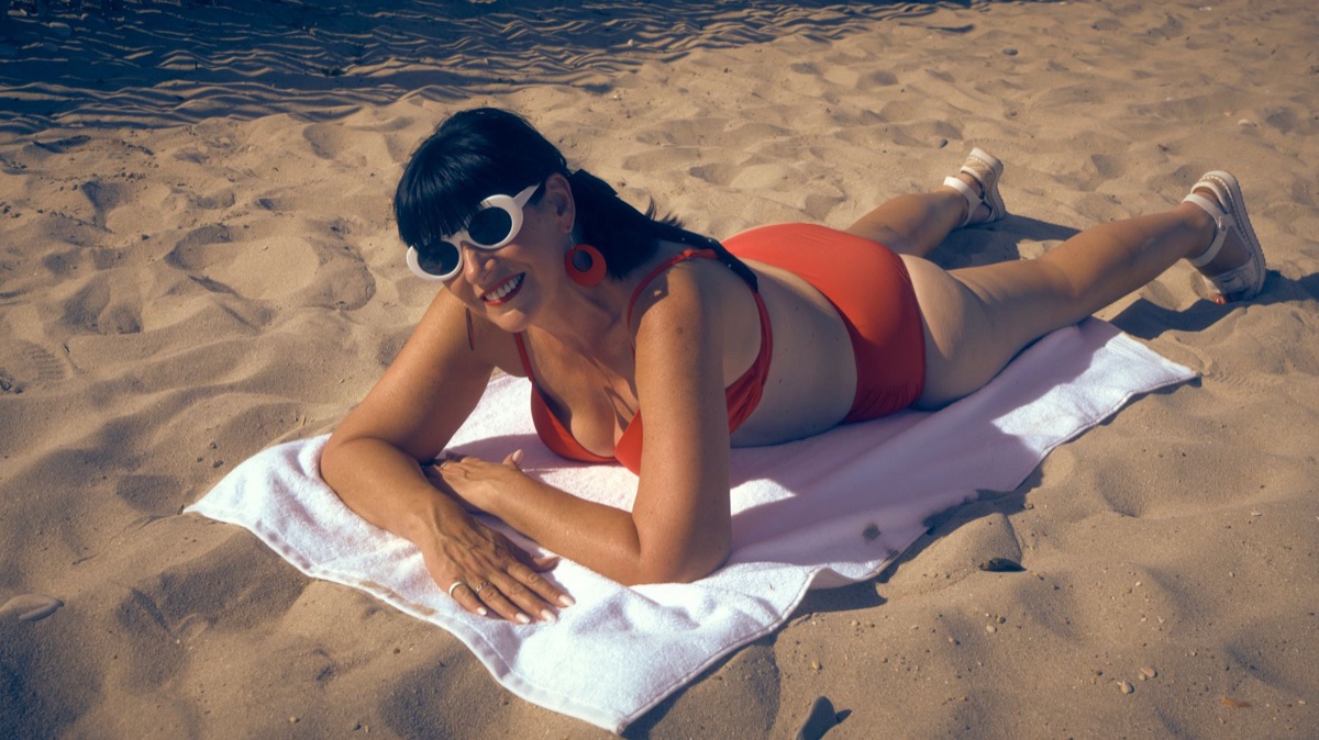 Pessoa deitada na areia branca no Bahamar
