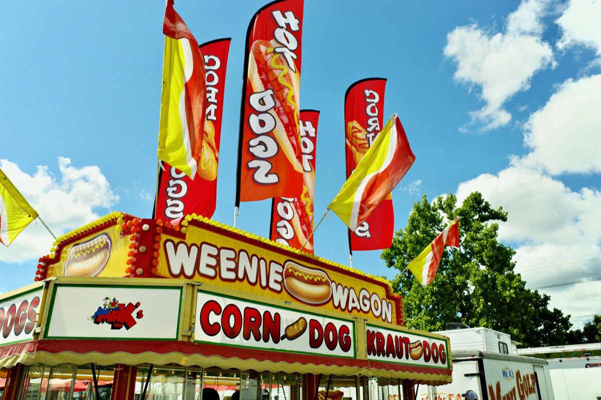 Festival vendor stand with colorful flags