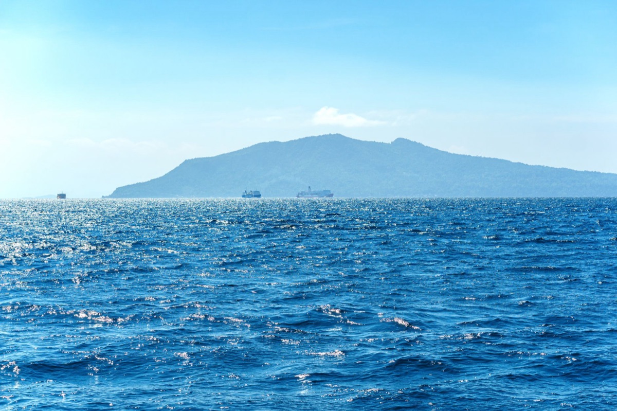 Tropical island with distillery in the distance